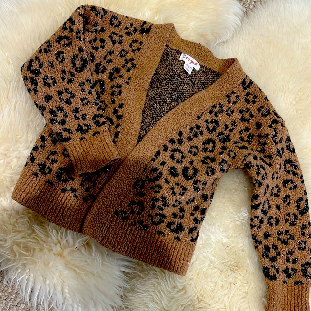 Used Cheetah/ Leopard print cardigan. Good condition with a little blue paint.